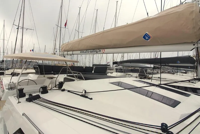  Yacht Photos Pics 2024 Fountaine Pajot Catamaran Elba 45 docked, showcasing sleek design and spacious deck.