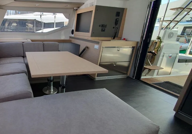  Yacht Photos Pics 2024 Fountaine Pajot Catamaran Elba 45 interior with modern seating and dining area.
