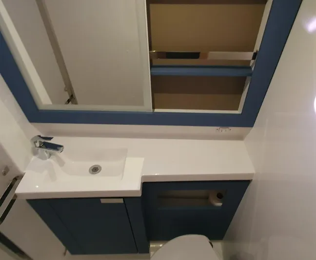  Yacht Photos Pics Modern bathroom interior of 2024 Fountaine Pajot Catamaran Elba 45 with sleek sink and mirror.