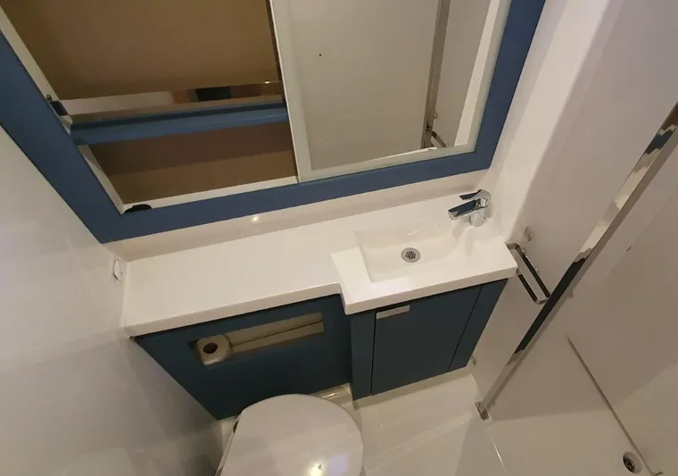  Yacht Photos Pics 2024 Fountaine Pajot Catamaran Elba 45 bathroom with modern sink and mirror.