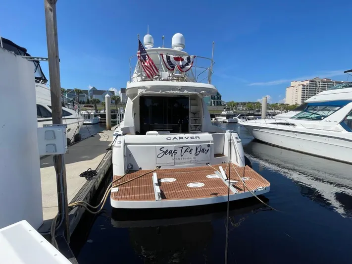 Seas The Day Yacht Photos Pics 2006 Carver 56 Voyager yacht docked at marina, rear view with American flag.