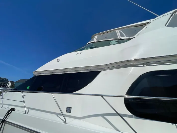 Seas The Day Yacht Photos Pics 2006 Carver 56 Voyager yacht with sleek design against a clear blue sky.