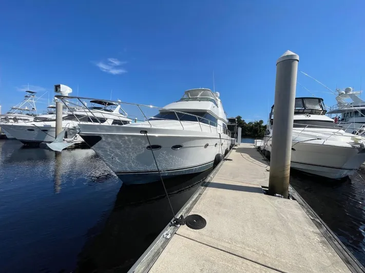 Seas The Day Yacht Photos Pics 2006 Carver 56 Voyager yacht docked at marina under clear blue sky.