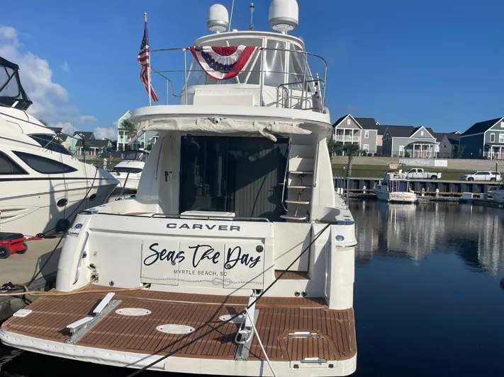 Seas The Day Yacht Photos Pics 2006 Carver 56 Voyager yacht docked, displaying "Seas The Day" at Myrtle Beach marina.