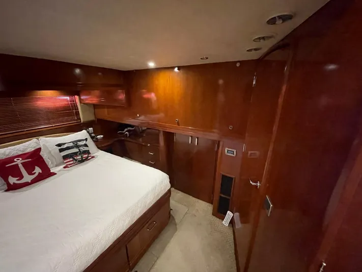 Seas The Day Yacht Photos Pics Luxurious cabin interior of 2006 Carver 56 Voyager yacht with wood paneling and cozy bedding.