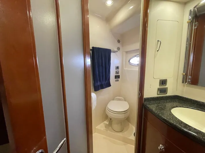 Seas The Day Yacht Photos Pics Bathroom interior of 2006 Carver 56 Voyager yacht, featuring toilet and sink.