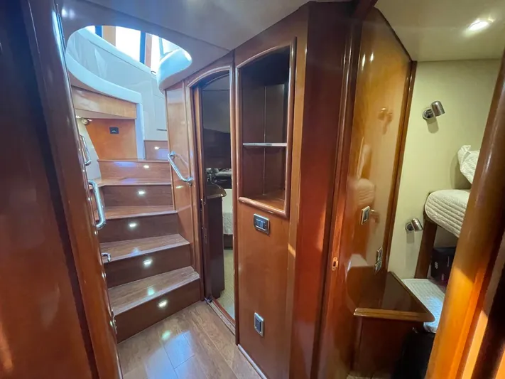 Seas The Day Yacht Photos Pics Interior of 2006 Carver 56 Voyager yacht with wooden finishes and staircase.