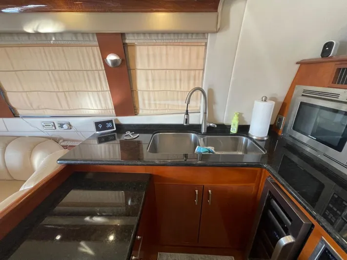 Seas The Day Yacht Photos Pics Luxurious kitchen interior of 2006 Carver 56 Voyager yacht with modern amenities.