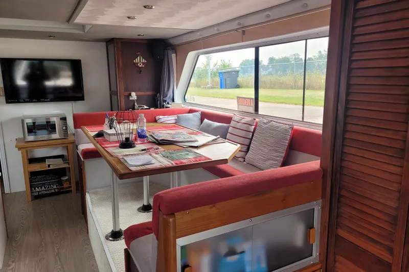 Merjo 6 Yacht Photos Pics Cozy interior of 2014 ARTISANAL Ml-50 with dining area and large window view.