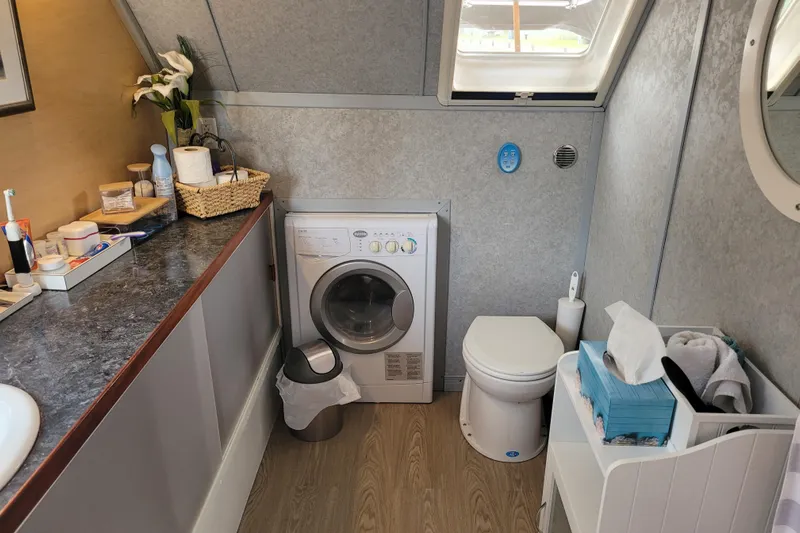 Merjo 6 Yacht Photos Pics Compact bathroom with washing machine, toilet, and countertop essentials; ARTISANAL Ml-50, 2014 model.