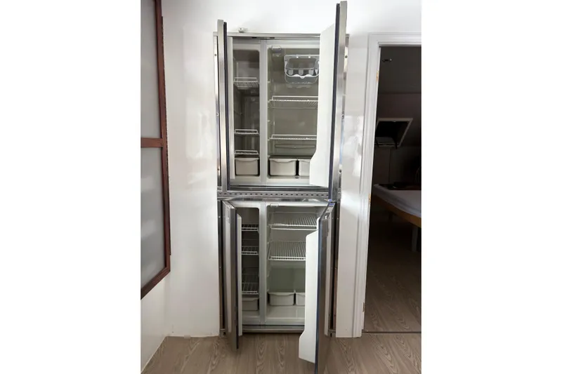 Merjo 6 Yacht Photos Pics Stainless steel ARTISANAL Ml-50 refrigerator, 2014 model, with open double doors in a modern kitchen.