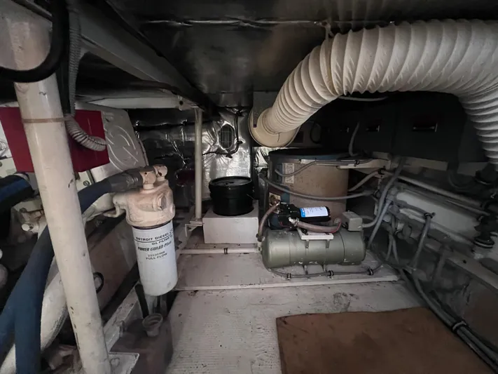 " A La Mer " Yacht Photos Pics Engine room of a 1988 Bertram 43 Convertible yacht with various mechanical components.