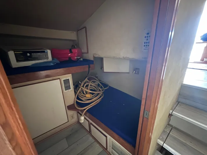 " A La Mer " Yacht Photos Pics 1988 Bertram 43 Convertible interior cabin with storage and equipment.