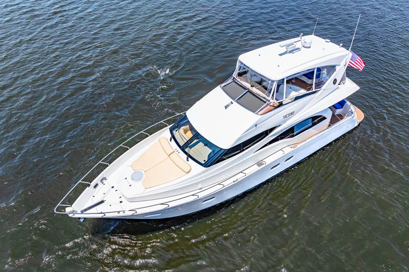 Victory Yacht Photos Pics Aerial view of a 2005 Marquis 59 yacht cruising on open water.