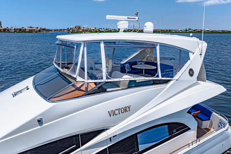 Victory Yacht Photos Pics Luxury 2005 Marquis 59 yacht named "Victory" cruising on a serene waterway.