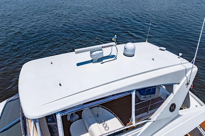 Victory Yacht Photos Pics 2005 Marquis 59 yacht top view with radar equipment on calm water.