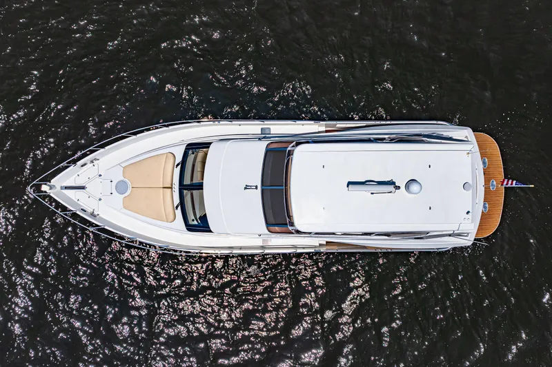 Victory Yacht Photos Pics Aerial view of 2005 Marquis 59 yacht on dark water.