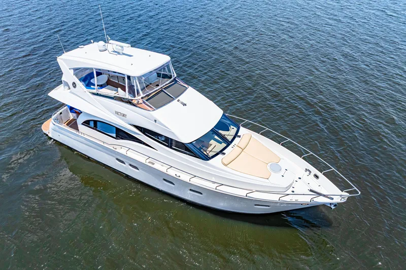 Victory Yacht Photos Pics 2005 Marquis 59 yacht cruising on open water, aerial view.