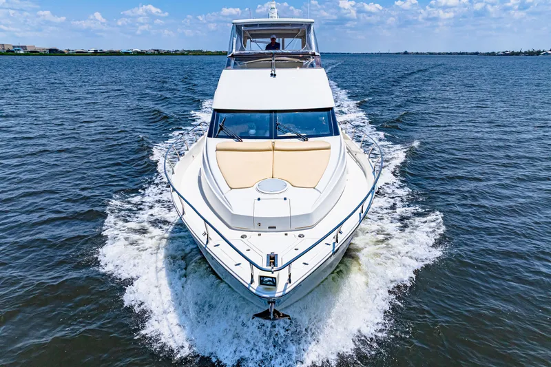 Victory Yacht Photos Pics 2005 Marquis 59 yacht cruising on open water under a clear blue sky.