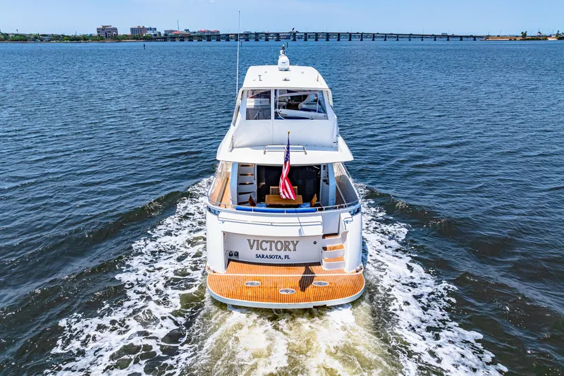 Victory Yacht Photos Pics Luxury Marquis 59 yacht cruising on open water, rear view, 2005 model.