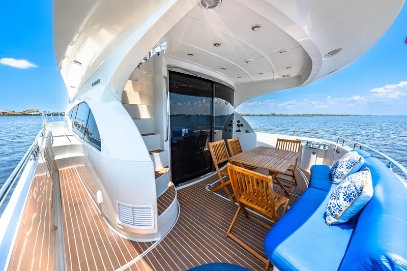 Victory Yacht Photos Pics Luxurious 2005 Marquis 59 yacht deck with seating, table, and ocean view.
