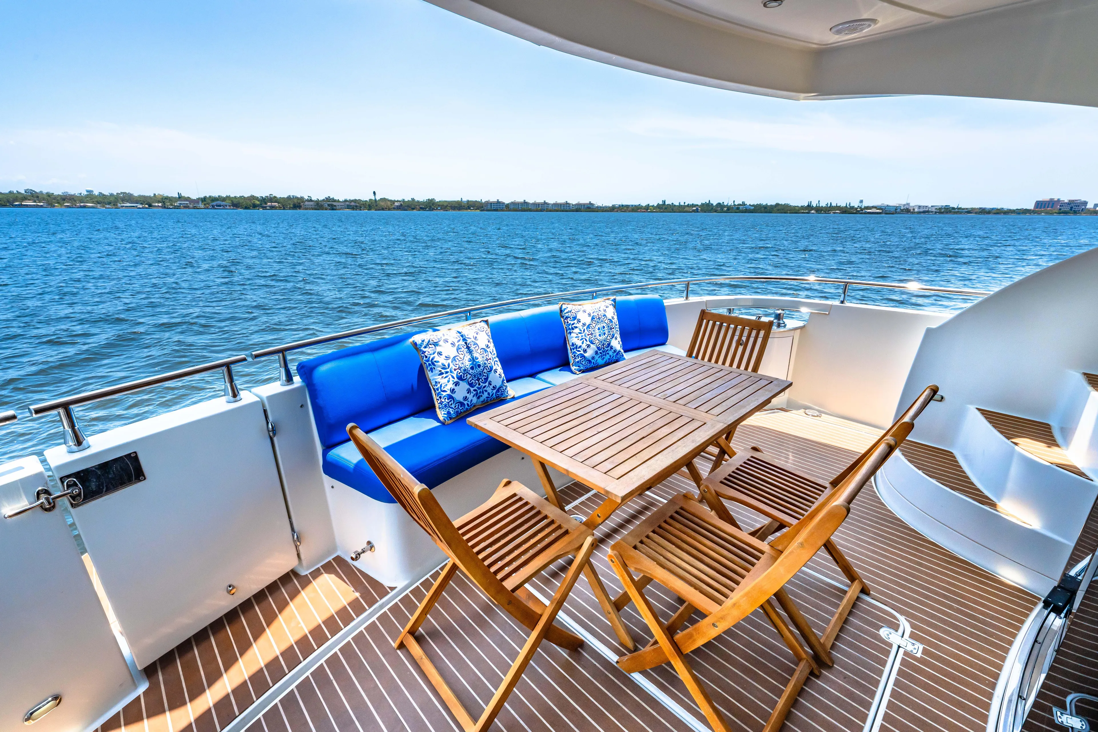 Victory Yacht Photos Pics Luxurious 2005 Marquis 59 yacht deck with wooden furniture and ocean view.