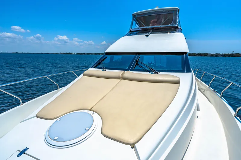 Victory Yacht Photos Pics Luxury 2005 Marquis 59 yacht on open water under clear blue sky.