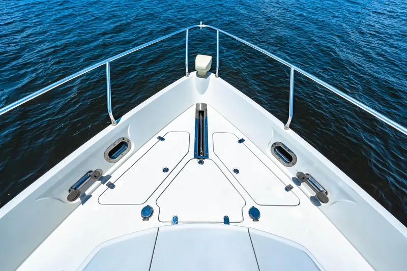 Victory Yacht Photos Pics Bow of 2005 Marquis 59 yacht on open water, showcasing sleek design and railing.