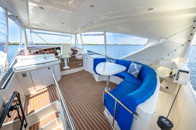 Victory Yacht Photos Pics Luxurious 2005 Marquis 59 yacht interior with blue seating and scenic water view.