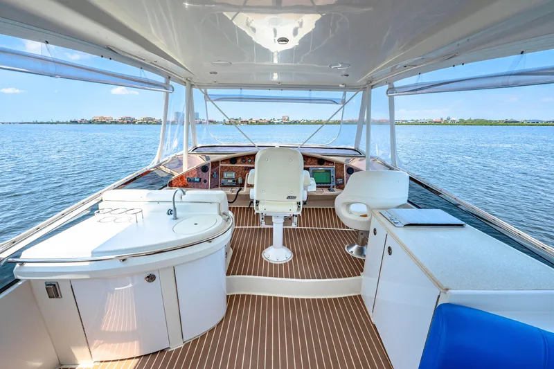 Victory Yacht Photos Pics Luxurious 2005 Marquis 59 yacht interior with helm, seating, and panoramic water views.