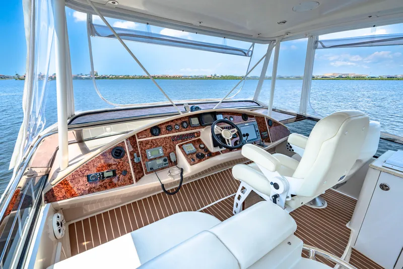 Victory Yacht Photos Pics Luxurious 2005 Marquis 59 yacht helm with leather seating and panoramic water views.