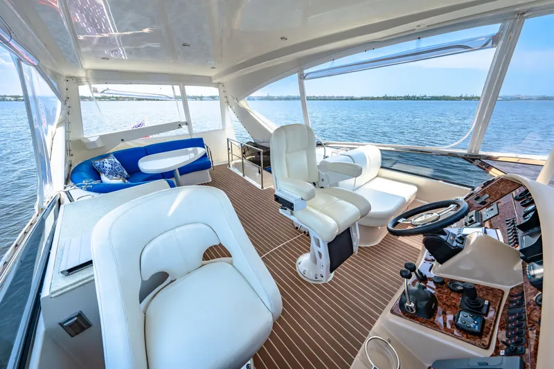 Victory Yacht Photos Pics Luxurious 2005 Marquis 59 yacht interior with plush seating and scenic water view.