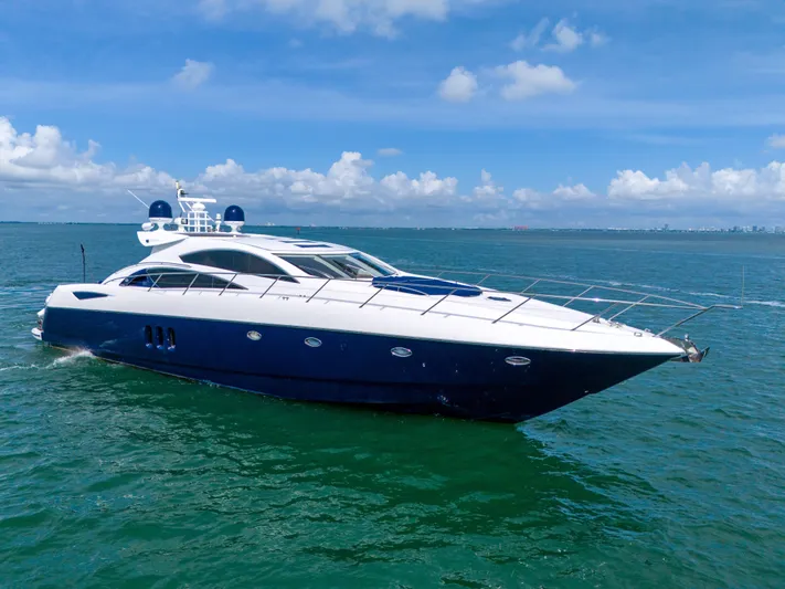  Yacht Photos Pics Sunseeker Predator 72 yacht, 2006 model, cruising on open water under a clear blue sky.