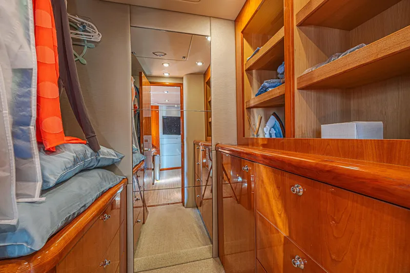 Big Chubby Xl Yacht Photos Pics Luxurious interior of a 2006 Sunseeker 75 Yacht with wooden cabinetry and shelving.