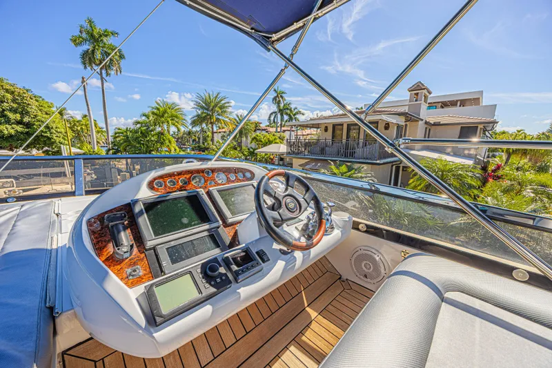 Big Chubby Xl Yacht Photos Pics Sunseeker 75 Yacht 2006 helm with luxurious controls, surrounded by tropical scenery.