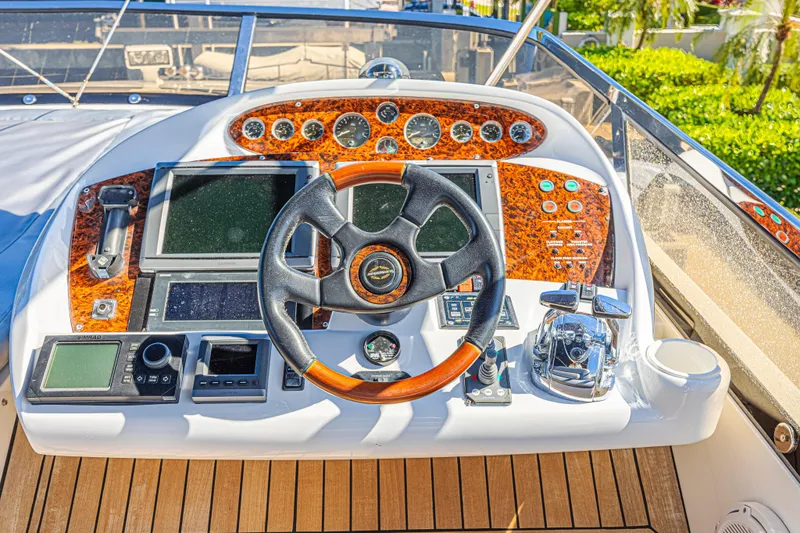 Big Chubby Xl Yacht Photos Pics Cockpit of 2006 Sunseeker 75 Yacht with luxurious controls and wooden accents.