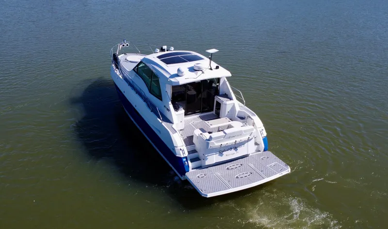 Radical Physics Yacht Photos Pics 2012 Cruisers Yachts 48 Cantius on calm water, rear view.