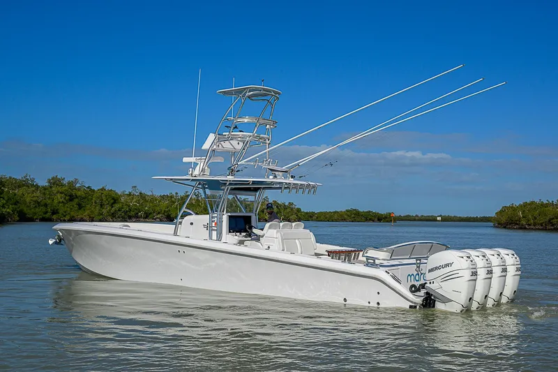 Mare Yacht Photos Pics 2019 Bahama 41 boat with multiple outboard engines on a calm waterway.