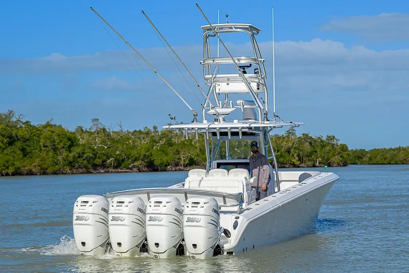 Mare Yacht Photos Pics 2019 Bahama 41 boat with four engines cruising on a calm waterway.