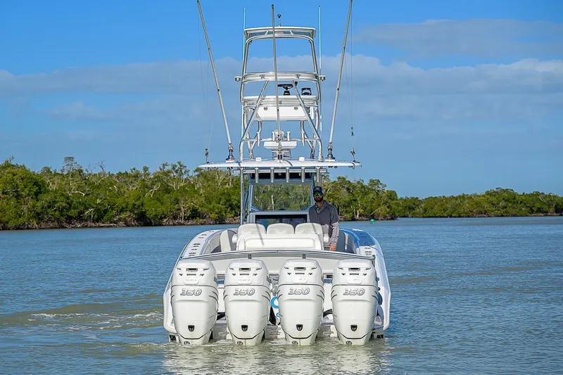 Mare Yacht Photos Pics 2019 Bahama 41 boat with four engines cruising on a calm waterway.