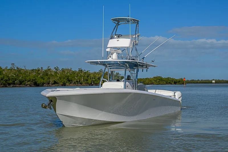 Mare Yacht Photos Pics 2019 Bahama 41 boat cruising on calm water under clear blue sky.
