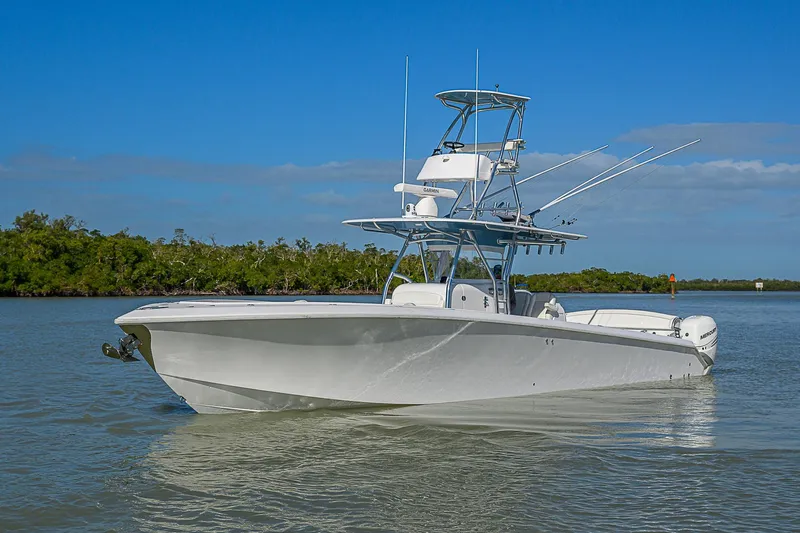 Mare Yacht Photos Pics 2019 Bahama 41 boat on calm water with clear blue sky background.