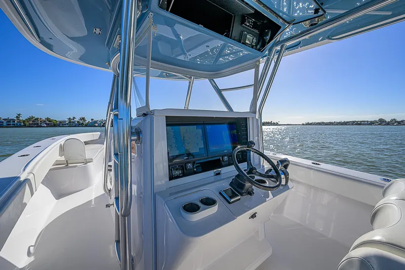 Mare Yacht Photos Pics 2019 Bahama 41 boat cockpit with modern navigation system, steering wheel, and ocean view.