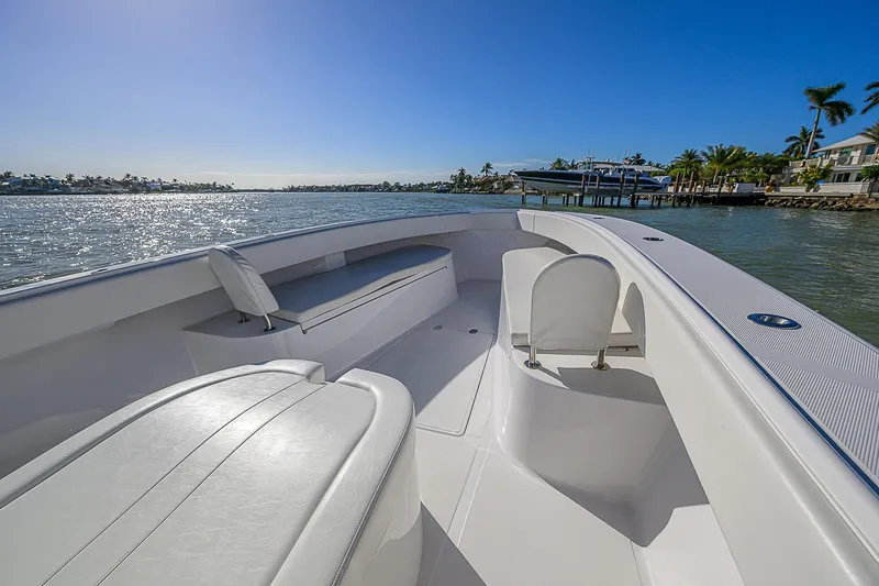 Mare Yacht Photos Pics 2019 Bahama 41 boat interior with seating, overlooking calm waters and clear blue sky.