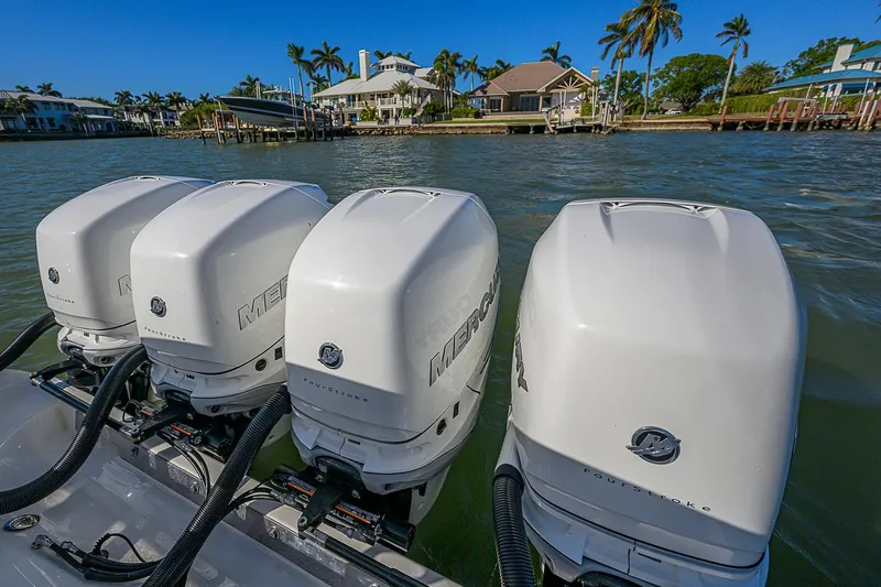 Mare Yacht Photos Pics Four Mercury outboard engines on a 2019 Bahama 41 boat, with waterfront homes in the background.