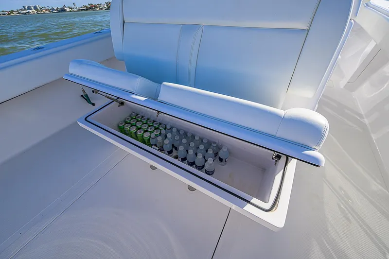 Mare Yacht Photos Pics 2019 Bahama 41 boat seat storage with drinks, featuring water bottles and soda cans.