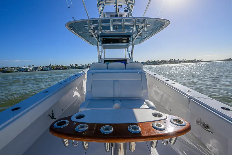 Mare Yacht Photos Pics 2019 Bahama 41 boat interior with seating and rod holders, cruising on a sunny day.