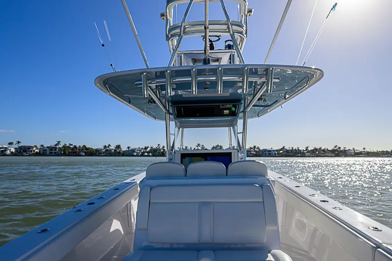Mare Yacht Photos Pics 2019 Bahama 41 boat on water, sunny day, clear blue sky, coastal view.