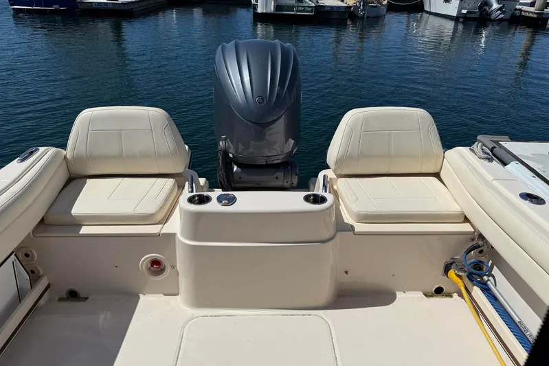  Yacht Photos Pics 2023 Grady-White Adventure 218 boat interior with seating and motor at marina.