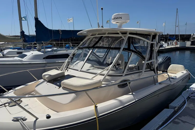  Yacht Photos Pics 2023 Grady-White Adventure 218 boat docked at marina with Garmin equipment.
